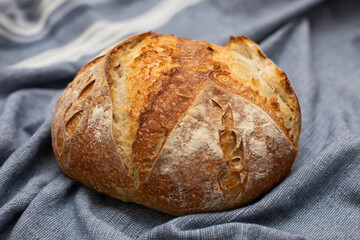 Beautiful Rustic Fresh Loaf of Sourdough Bread on Blue background