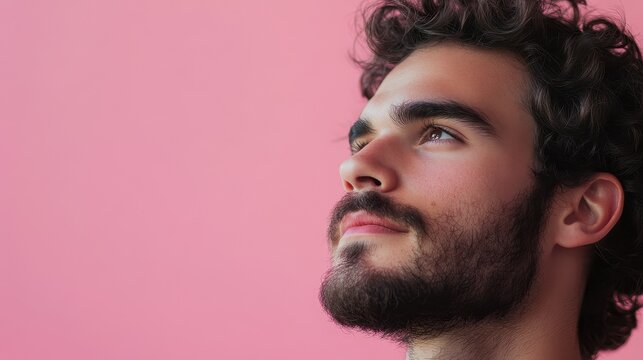An actor with a contemplative gaze, framed in an artistic composition. Pink background, with glowing accents