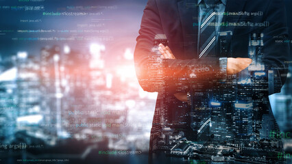 A businessman stands confidently in front of a city skyline illuminated at night. Digital elements surround him, symbolizing technology and innovation in business landscapes. Xenic