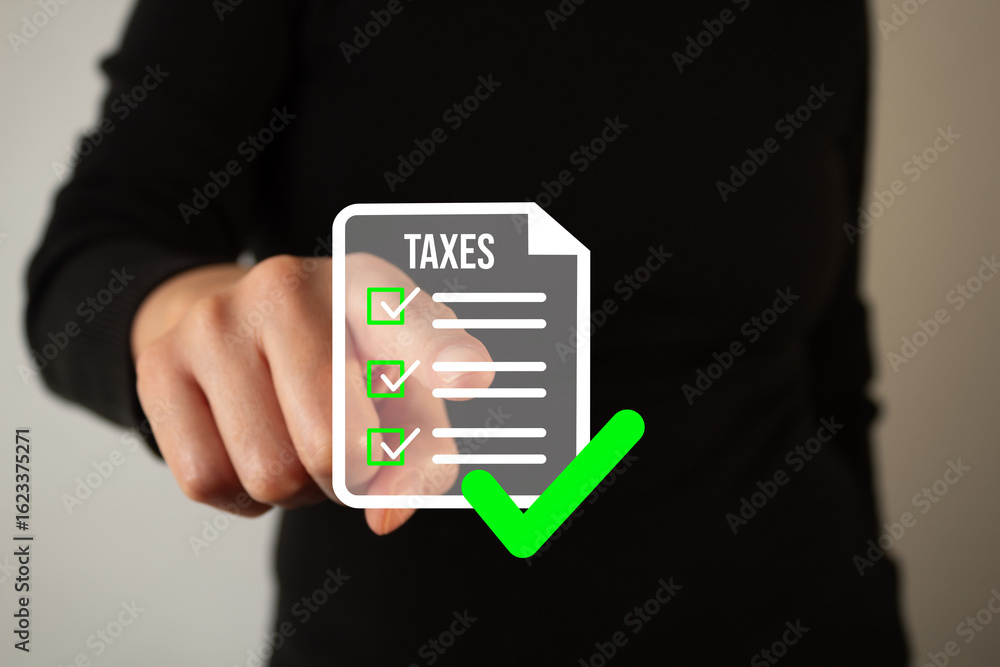 Poster hand of a person dressed in black pointing at a floating document with the word taxes and some check