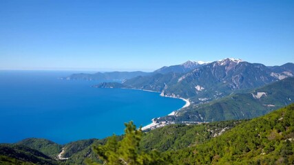 Scenic Turquoise Mediterranean Sea Coastline View from Verdant Green Mountain under Clear Blue Sky Snowy Peaks in the Distance on Sunny Day - Powered by Adobe