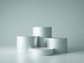 A photograph of four stark white cylindrical pedestals arranged as a multi-level product display stand on a clean, minimalist background.