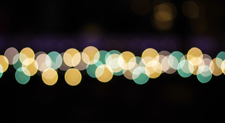 Bokeh lights in various colors against a dark background — soft blur aesthetic for festive or cozy vibe