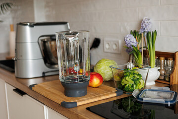 Healthy ingredients for detox smoothie drink and lifestyle diet. Glass blender bowl, apple, banana,...