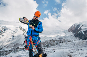 Climber in mountaineering Gear on glacier during Lenin peak ascent under mountain peaks in...