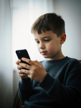 boy holding and starrring at smartphone, generative AI