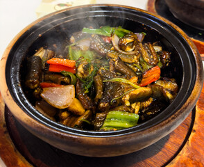 Wok with vegetables and eel on a plate. Food plate