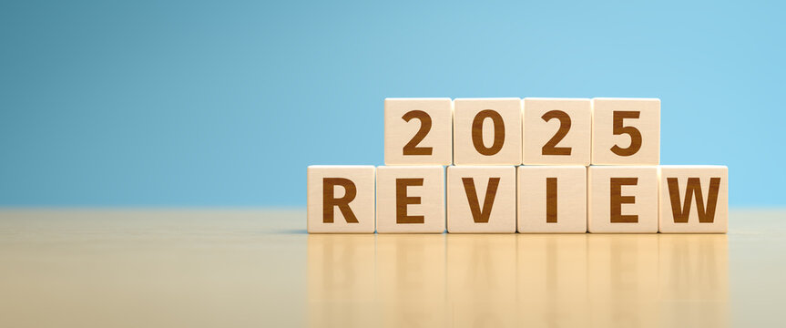 Wooden toy cubes forming the text "2025 REVIEW". Concept for reviewing what happened in the year 2025.