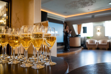 An Elegant Celebration Featuring Champagne Glasses in a Lavish Venue, Setting the Perfect Ambiance for a Memorable Event or Party that Exudes Class and Sophistication. Gather in Style