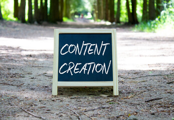 Content creation symbol. Concept word Content creation on chalk blackboard. Beautiful forest...