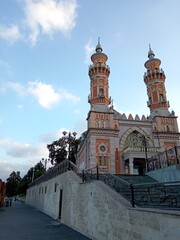 Sunni Mukhtarov Mosque in Vladikavkaz - elegant early 20th century Islamic architecture with minaret against Caucasus mountains