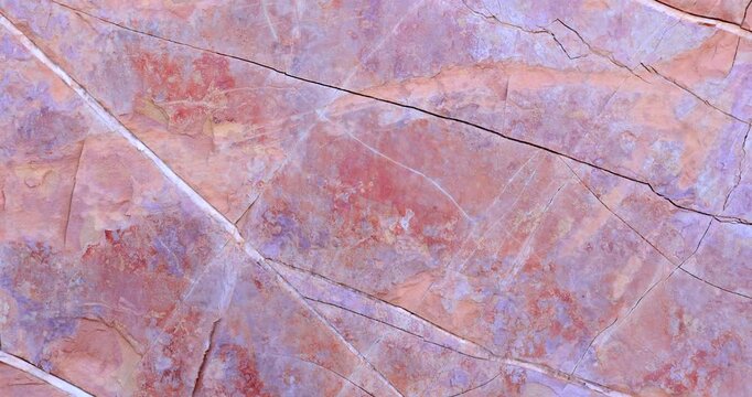Closeup pull back movement of smooth texture pink rock with cracks and crevice pattern