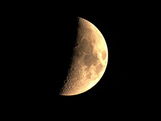 First Quarter Moon – Detailed Close-Up of Lunar Surface with Craters.
