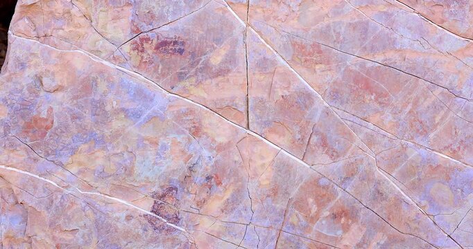 Slider pan of smooth pink rock with cracks and abstract crevice surface pattern