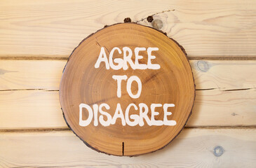 Agree to disagree symbol. Concept words Agree to disagree on beautiful wooden circle. Beautiful...