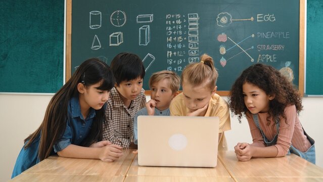 Top view diverse student looking at laptop and learning about coding engineering code and generating AI. Skilled children working together while brainstorm idea and planning creative plan. Pedagogy.