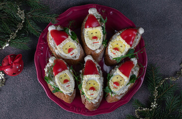 Homemade holiday sandwiches with sprats in shaped of Santa