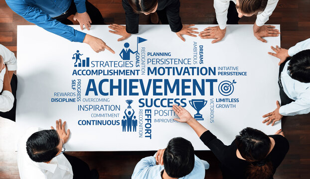 Aerial view of a diverse team of professionals discussing key concepts of achievement and success during a meeting. Focus on collaboration and motivation in business. Amity