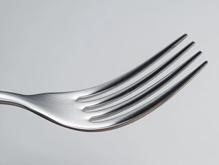 Macro Closeup of Stainless Steel Fork on Light Grey Background