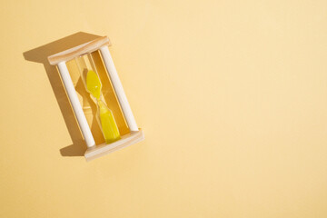 Hourglass on a colored background with space for text. Concept of lack of time and deadline.