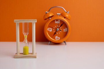Hourglass on a colored background with space for text. Concept of lack of time and deadline.