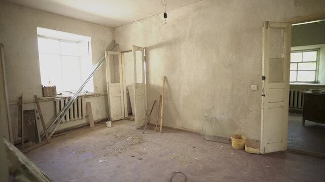 Interior of Old House in Need of Repair. Panoramic view from inside an old, damaged house. View moves from right to left, revealing the state of disrepair.