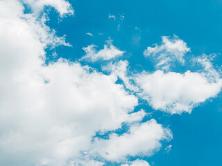 Bright blue sky with soft white clouds on a sunny day, perfect for nature, travel or relaxation...