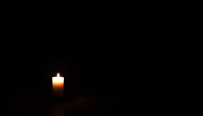 Candle lit in darkness symbolizing warmth and love for Valentine’s Day  