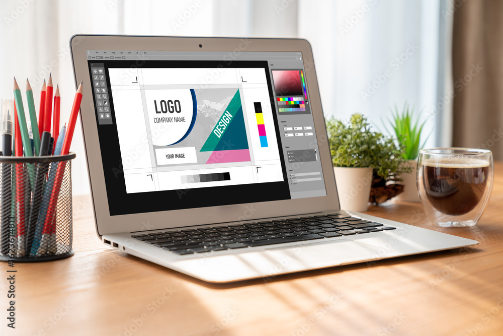 Poster graphic designer software for modern design of web page and commercial ads showing on the computer s