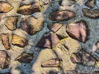 Rustic Fieldstone Wall with Dappled Shadows