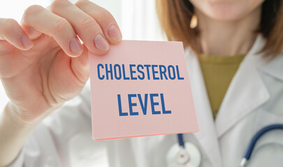 A woman is holding a card that says Cholesterol Level
