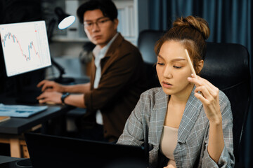 Serious face of thinking businesswoman focusing computer to report data analysis social media...