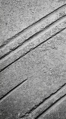 Abstract gray texture with diagonal lines and subtle variations in tone.