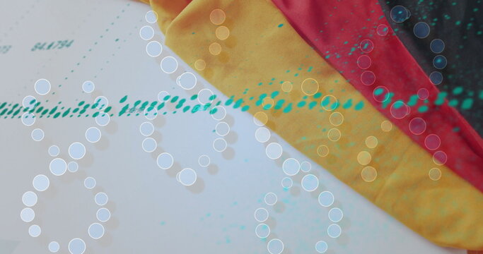 Fototapeta Layering striped yellow red black fabric over printed sheet on tabletop with teal dots and overlays