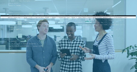 Discussing three software developers examining code on tablet in office, with coding wall and plant
