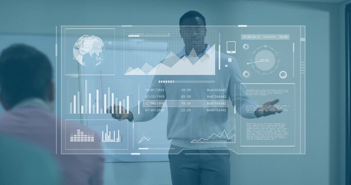 Presenting African American man wearing sweater showing data on holographic display in meeting room - Powered by Adobe