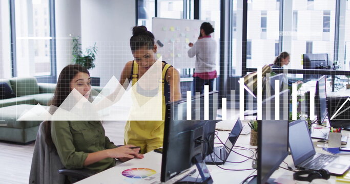 Collaborating two coworkers typing and pointing at screen in shared office, with color wheel