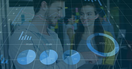 Four professionals examining laptop data in modern office meeting area, with business casual attire