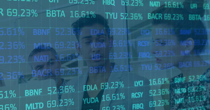 Reviewing analyst team examining scrolling tickers on glass wall in office, with binders