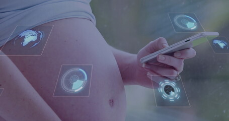 Displaying pregnant torso holding smartphone in softly lit interior, with holographic UI elements