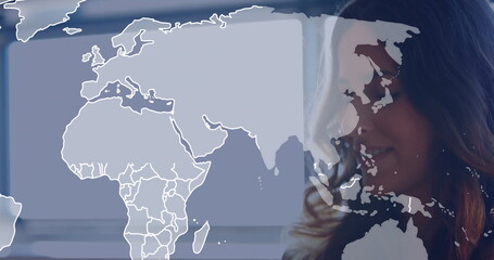 Standing woman wearing business casual inside office with world map overlay and blinds, copy space