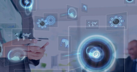 Holding smartphone, business executive manipulating holographic interface in office, copy space