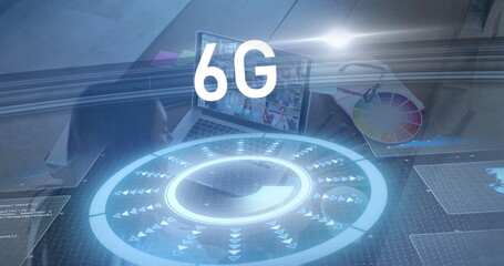 Mid-adult female interacting with holographic 6G interface in office, with laptop and color wheel