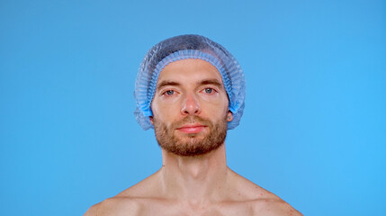 Portrait of a man wearing surgical cap in medical setting