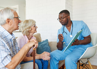 Doctor or nurse caregiver showing a prescrption or documents to senior couple at home or nursing...