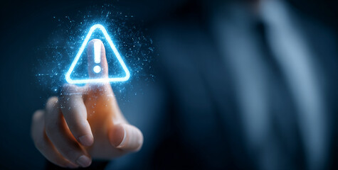 Blue digital caution icon glows, touched by a hand. Shows warning, attention, or alert for tech, digital interfaces, presentations.