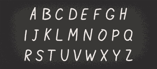 Chalk alphabet drawn on a chalkboard. Hand-drawn uppercase letters with chalk texture on a black board, perfect for school, education and creative design projects.