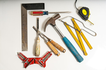 Carpenter tools lying on white background ready for building project