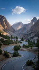 Fototapeta premium Winding road through a majestic mountain valley under a cloudy sky