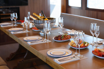 Experience an Elegant Dining Setup on a Luxurious Yacht, Featuring Exquisite Gourmet Cuisine